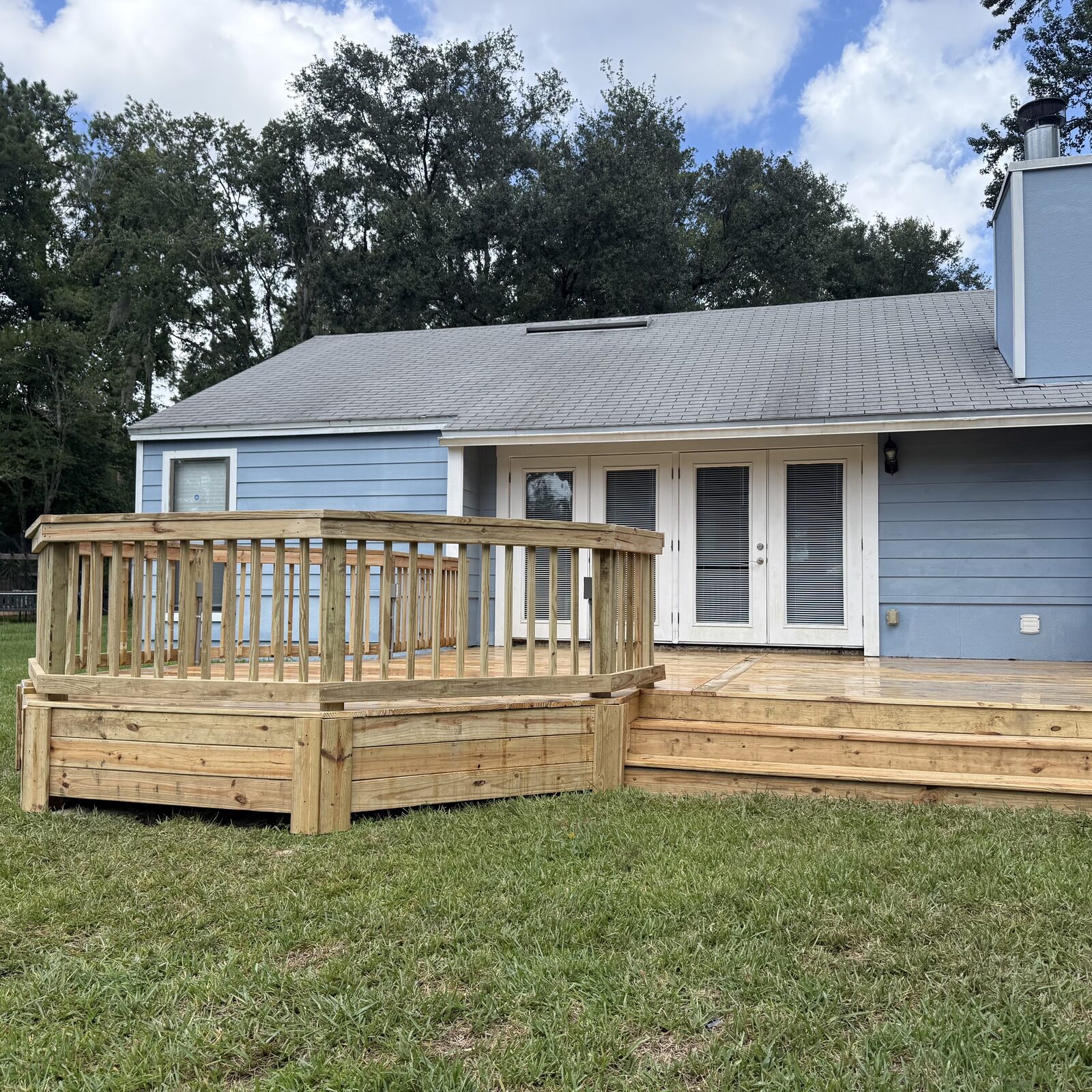 Pressure-treated pine wood deck with wraparound rail, Fleming Island FL
