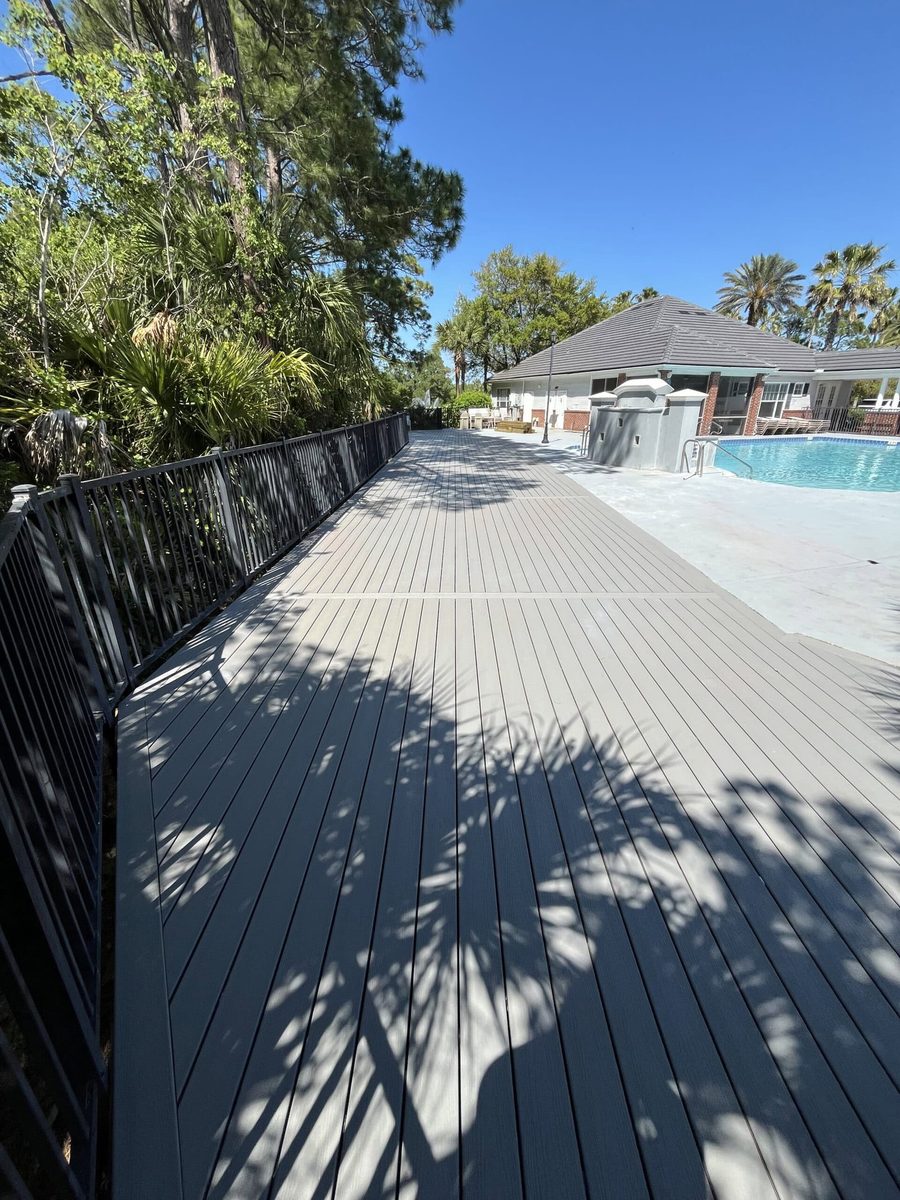 Composite poolside walkway with black railing on Anastasia Island