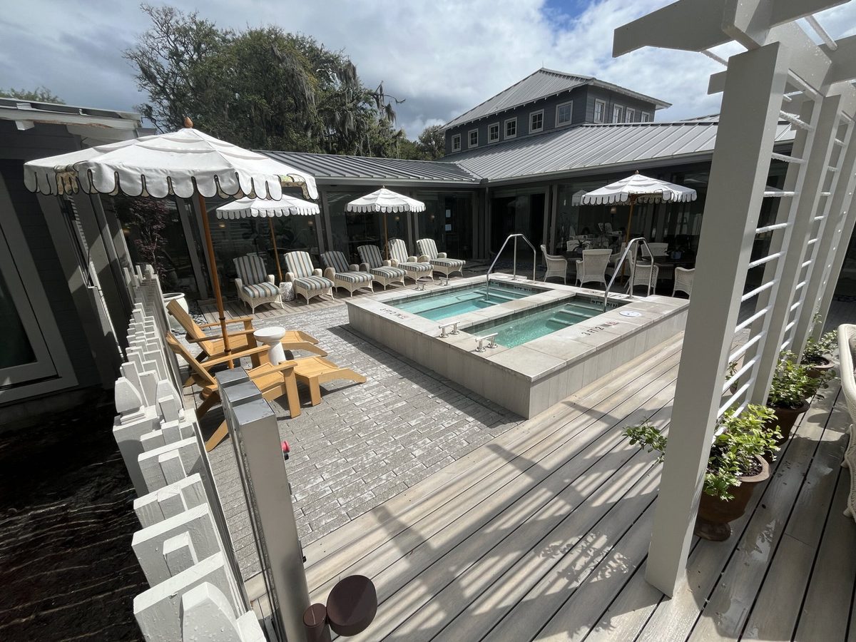 Weathered-gray composite deck with twin spas and pergola on a coastal Northeast Florida estate